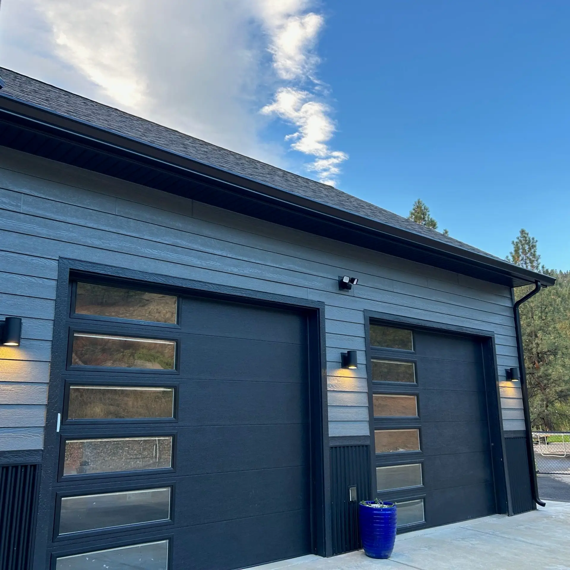 Contemporary flat panel garage doors installed by Elite Overhead Doors